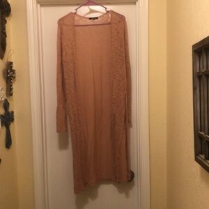 Long sleeve light pink sweater with slits on side. Size M